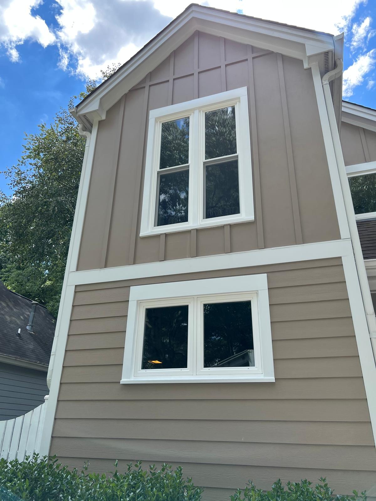 Two-story home in Fuquay-Varina, NC with newly installed white replacement windows